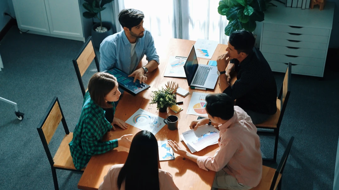 Business team working together to plan marketing strategy while looking at data analysis